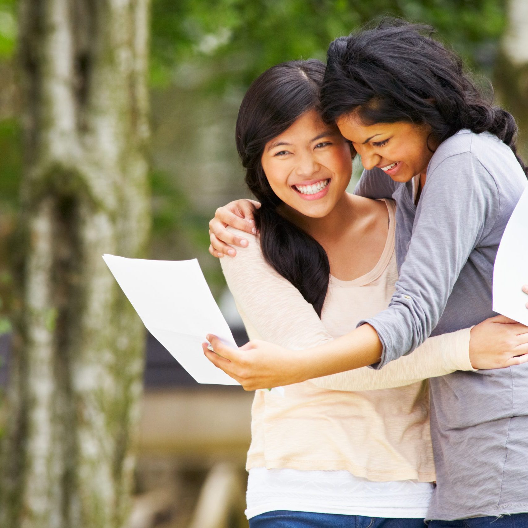 Two Teenage Girls Celebrating Successful Exam Results And Hugging