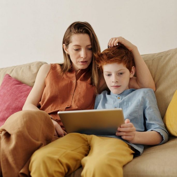 photo-of-woman-and-boy-watching-through-tablet-computer-4145349